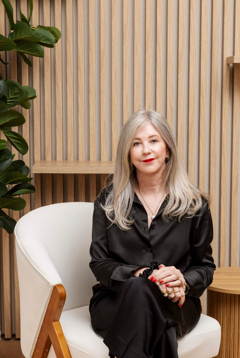 Dr Jenny Kimmins seated at Southern Cosmetics