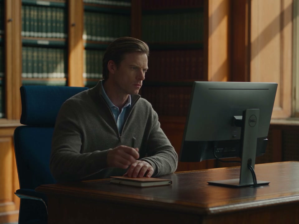 A clinic manager reviews a patient’s communication workflow at a fixed monitor
