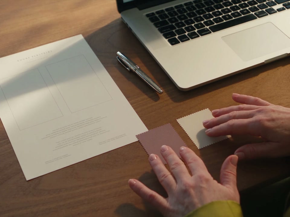 A clinic team member prepares patient-facing content at a desk