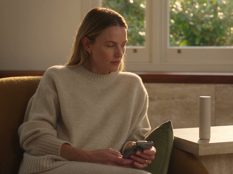 A patient checks her phone in a quiet moment at home