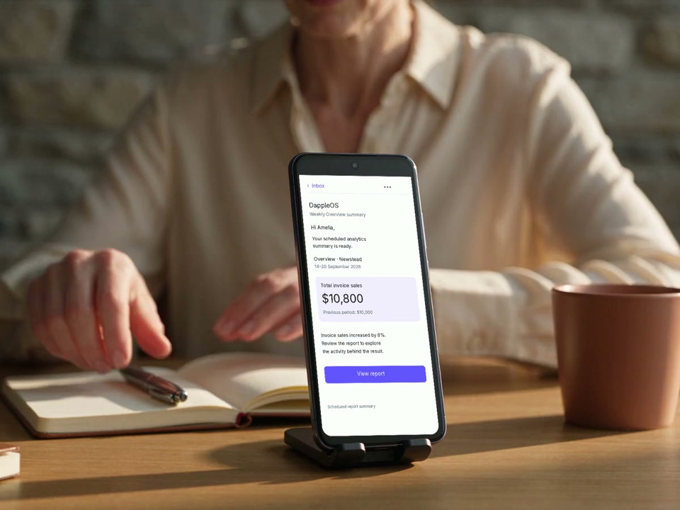 A DappleOS report-summary email on a supported phone at a clinic desk
